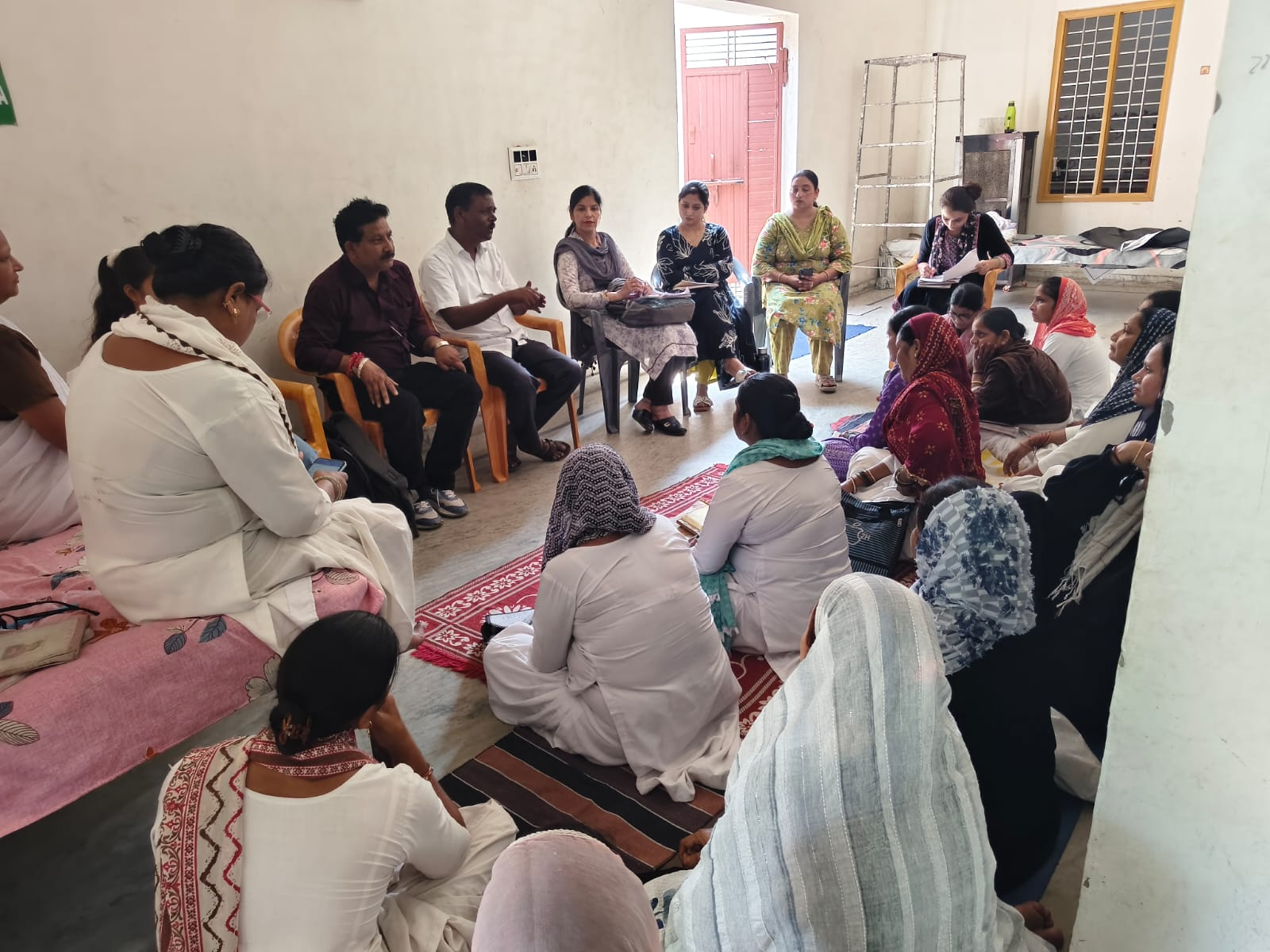 Women and community members seated in a group discussion